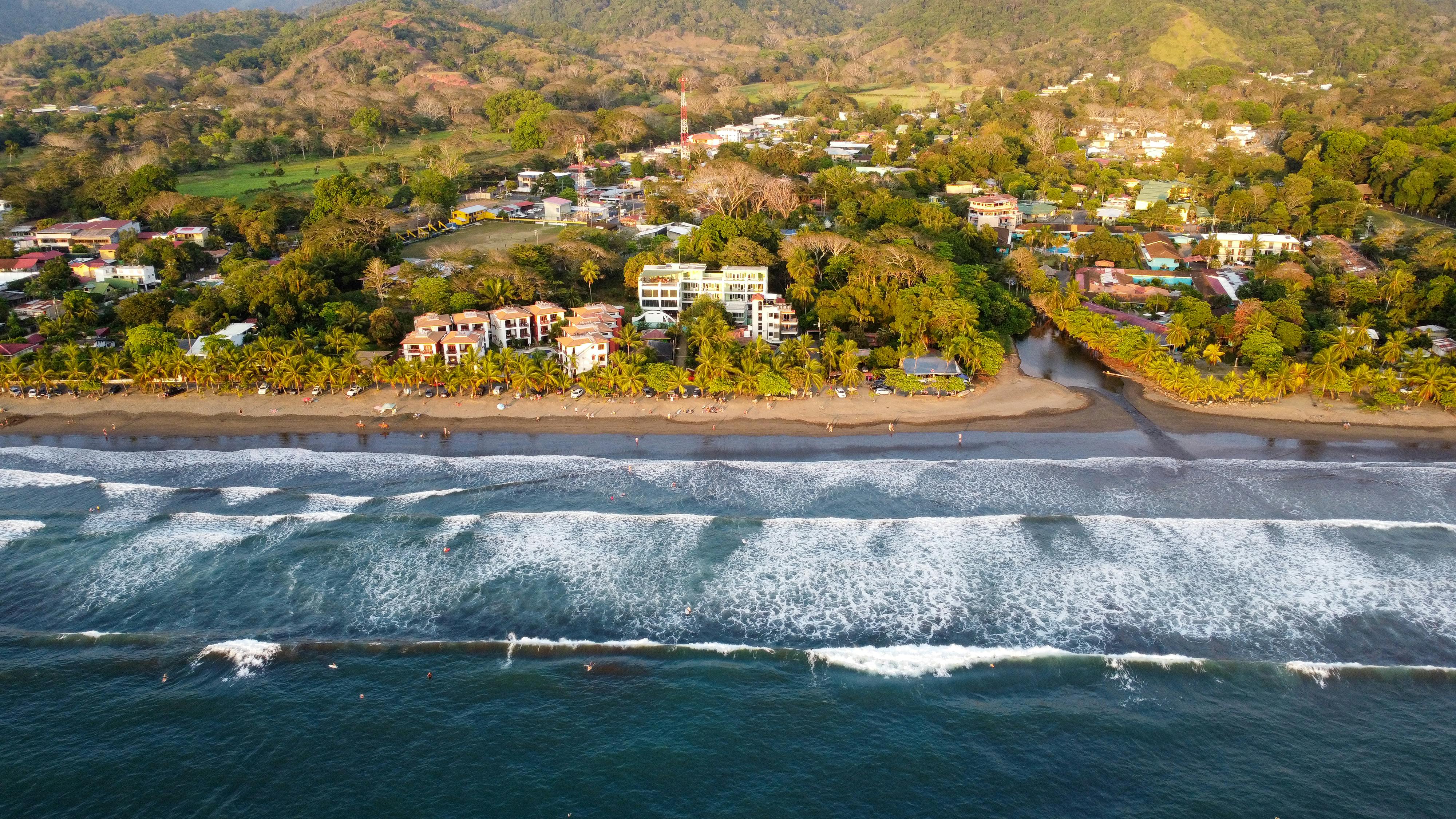 Playa Jacó, Costa Rica - tropical beach with lush green mountains